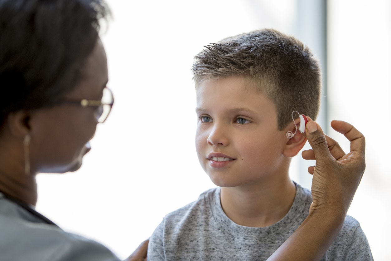 Young boy is fitted with hearing aid