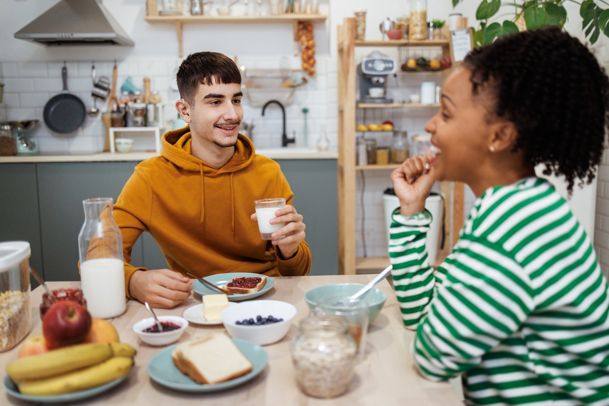 Teenager with hearing aids having lunch with a friend