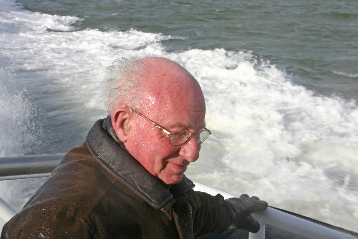 Man with hearing aids enjoying a boating trip